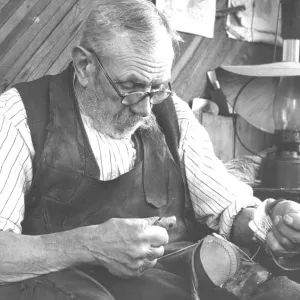 85 year old Jacob Playfoot of East Lynn near Tonbridge Kent peers through his spectacles