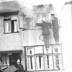 Firemen tend to a fire at Alma house on Old Farm Avenue in Sidcup, Kent