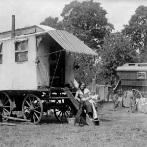 A gypsy woman sitting on the steps to her Romany caravan in the gypsy camp on Epsom Downs