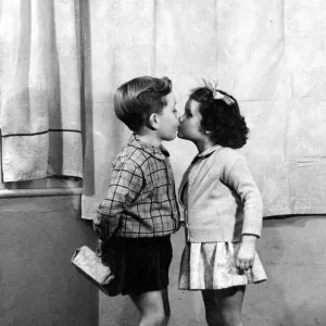1956 Christmas Mistletoe Print: Young Couple's Romantic Moment 1956 Christmas Mistletoe Print: Young Couple's Romantic Moment