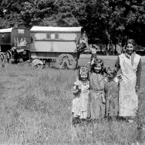 Romany gypsy girls posing outside their caravans on Epsom Downs during the Epsom