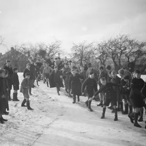 Schoolboys sliding on the snow in Orpington, Kent. 1937