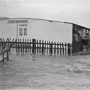 Sea defences broken by flood tide at Winchelsea, bungalows flooded and holidaymakers