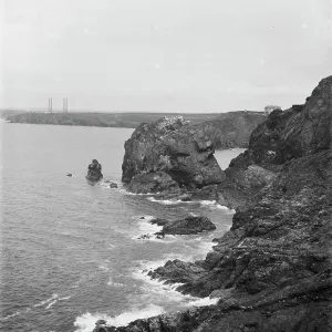 A distant view of the four wooden Marconi wireless towers at Poldhu, Mullion, Cornwall from Mullion Cove along the cliff. 1908