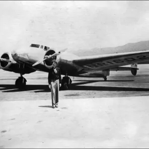 Print of Amelia Earhart standing in front of her plane Print of Amelia Earhart standing in front of her plane
