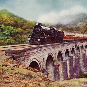 4-6-2 steam locomotive of the Bombay, Baroda and Central India Railway hauling the Frontier Mail passing over a viaduct between Bombay and Delhi (colour litho)