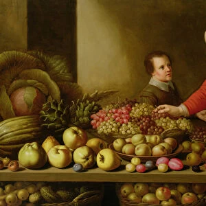 Girl selling grapes from a large table laden with fruit and vegetables