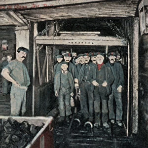 Group of miners in a lift cage in coal mine (photo)