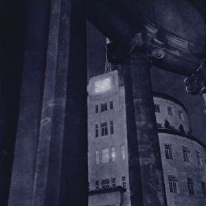 London at night: Broadcasting House, through the Porch of All Souls, Langham Place (b / w photo)