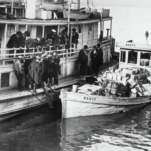 Rumrunner « Dante » anchored at the wharf with alcohol aboard and guarded by prohibition agents, New Orleans, USA, 1925 (b/w photo)