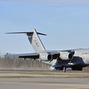A C-17 Globemaster III doing an assault landing on a new runway at Allen Army Airfield
