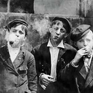 Missouri newsboys smoking on a street in St. Louis, 1910