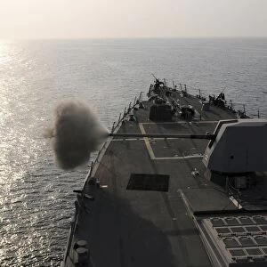 An Mk-45 lightweight gun is fired aboard guided missile destroyer USS Truxtun