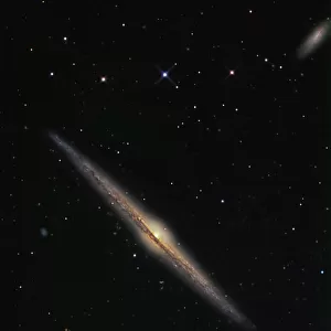 NGC 4565 is an edge-on barred spiral galaxy in the constellation Coma Berenices