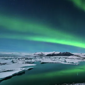 The northern lights dance over the glacier lagoon in Iceland