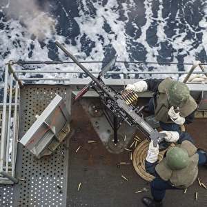 Sailors fire a. 50-caliber machine gun