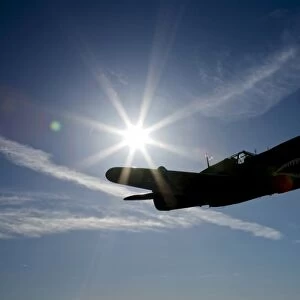 Silhouette of a Curtiss P-40E Warhawk in flight near Chino, California