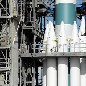 Solid rocket boosters are attached to the Delta II rocket in the mobile service tower