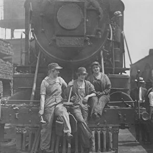 Women laborers seated on front of engine at Bush Terminal railroad yard, 1918