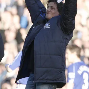 U. S. actor Stallone holds a scarf as he walks on the pitch at the English Premier League match betwe