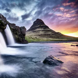 Kirkjufellsfoss waterfall at sunrise, with Kirkjufell mountain in the background, Snaefellsnes Peninsula, Western Iceland June