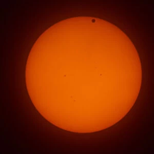 The transit of Venus across the face of the sun, with visible sunspots, as seen from Aurora