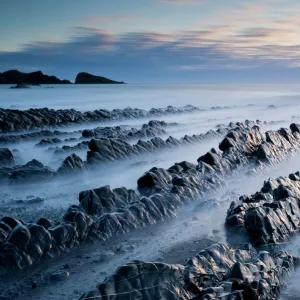 View of Welcombe Mouth with late evening light at high tide, North Devon, UK, March 2012