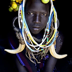 Young girl wearing traditional headdress, Mursi tribe, Mago National Park. Omo Valley