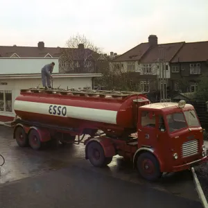 Ilford Esso petrol station with Leyland tanker making delivery 1964. Creator: Unknown