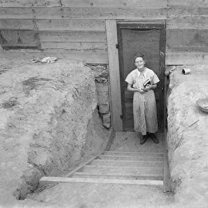 Mrs. Free in doorway of her basement dugout home, Dead Ox Flat, Oregon, 1939. Creator: Dorothea Lange