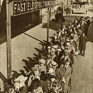 Passengers waiting at Goldhawk Road Station in London during the railway strike, 1919, (1935)