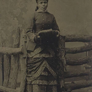 Tintype of woman in jacket and dress with hat and muff, 1880s. Creator: Unknown