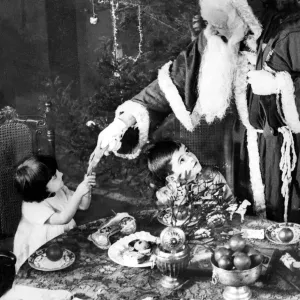 1922 Print of Father Christmas pulling a cracker 1922 Print of Father Christmas pulling a cracker