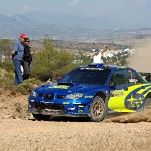FIA World Rally Championship: Petter Solberg, Subaru Impreza WRC, on Stage 3, with the town of Thiva in the background