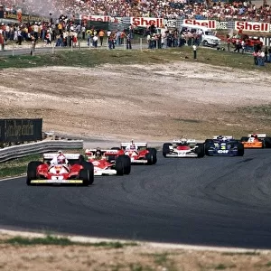 Formula One World Championship: Belated race winner Niki Lauda Ferrari 312T2 leads on the opening lap of the restarted race ahead of James Hunt McLaren M23