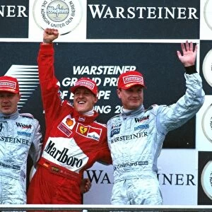 Formula One World Championship: L to R Mika Hakkinen Mclaren MP4-15, 2nd place, winner Michael Schumacher Ferrari F1 2000 and 3rd place David