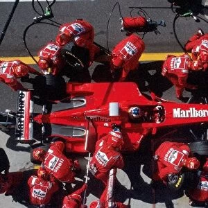 Formula One World Championship: Michael Schumacher Ferrari F300 makes a pit stop