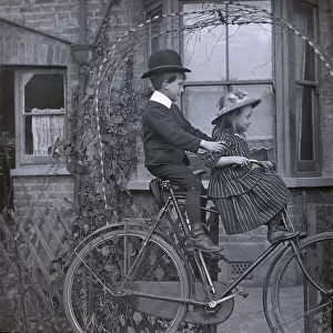 Boy and girl on a bike, edwardian