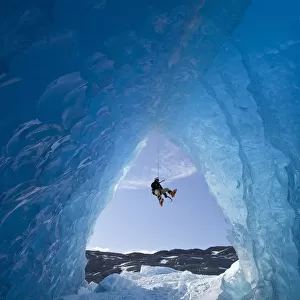 Composite: View From Inside An Ice Cave Of An Iceberg Frozen In Mendenhall Lake As An Ice Climber Rappels Down A Rope, Juneau, Southeast Alaska, Winter