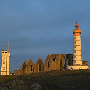 Lighthouse in the morning, Saint Mathieu lighthouse with ruin of Benedictine abbey, Pointe Saint-Mathieu, Plougonvelin, Finistere, Brittany, France