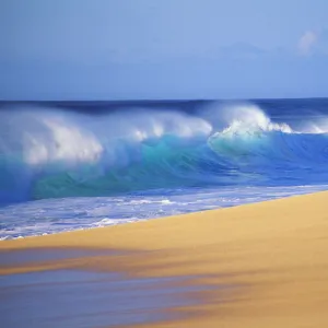 Shorebreak Waves Along Sandy Beach, Blue Sky