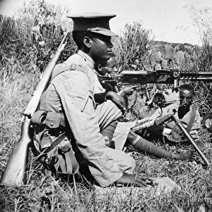 Abyssinian War September 1935 Abyssinian machine gunner firing an old Hotchkiss