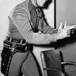 Actor Clayton Moore who plays the Lone Ranger in the televisin programme minus his guns