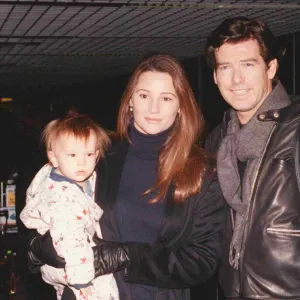 Actor Pierce Brosnan and girlfriend Keeley Shay Smith with baby Dylan Thomas arriving at