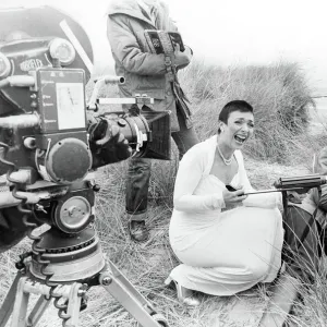 Actress Jacqueline Pearce as Servalan and Paul Darrow as Avon share a joke during filming