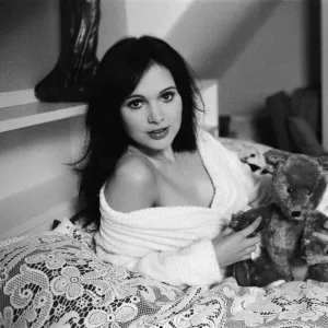 Actress Madeline Smith poses on the bed with her teddy bears. 2nd November 1973