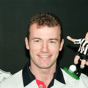 Alan Shearer holding his soccer figure from the Soccer Superheroes collection