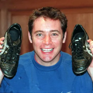 Ally McCoist actions football boots for Cash For Kids. Charity November