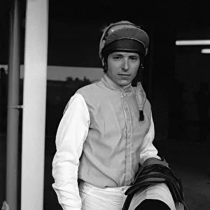 American jockey Steve Cauthen carrying his saddle and whip at Kempton Park, July 1987