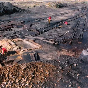 Archaeologists digging up a perfectly preserved wooden railway which had lain buried